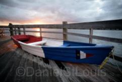 Boat on the dock of Pays de la Sagouine in Acadian colours.