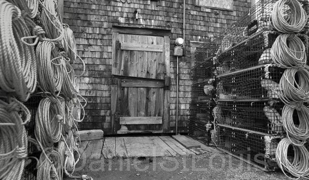 Black and white image of fishing traps and door.